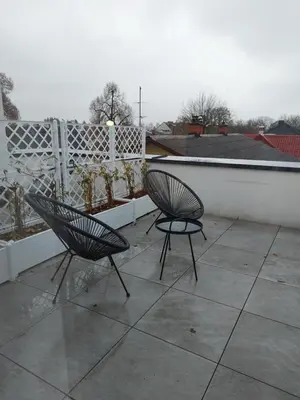 two chairs sitting on top of a patio at Bed & Breakfast Mozaik in Ljubljana