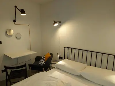 a bedroom with a bed and a desk and a chair at Bed & Breakfast Mozaik in Ljubljana