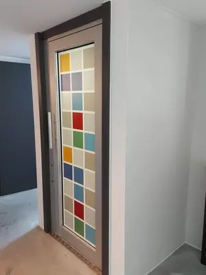a room with a door with colorful glass at Bed & Breakfast Mozaik in Ljubljana