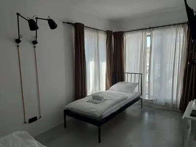 a bedroom with a bed in front of a window at Bed & Breakfast Mozaik in Ljubljana