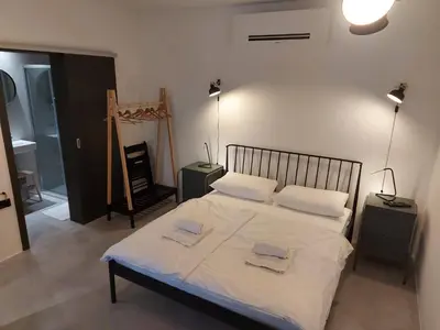 a bedroom with a bed with two towels on it at Bed & Breakfast Mozaik in Ljubljana