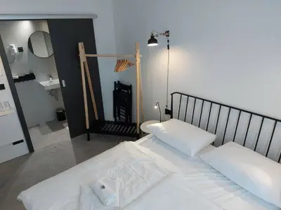 a bedroom with two white beds and a mirror at Bed & Breakfast Mozaik in Ljubljana