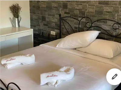 a white bed with two towels on top of it at Lovely apartment in nature with sauna in Postojna