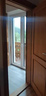 an open door with a view of a balcony at Sunny place in Kranjska Gora