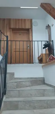 a set of stairs leading to a wooden door at Sunny place in Kranjska Gora