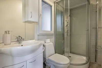 a bathroom with a toilet and a sink and a shower at Rooftop Home With Whirlpool & Sauna - Happy Rentals in Trebnje