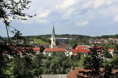 a town with a church in the middle of a city at Rooftop Home With Whirlpool & Sauna - Happy Rentals in Trebnje