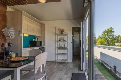 a kitchen and dining room with a table and chairs at Rooftop Home With Whirlpool & Sauna - Happy Rentals in Trebnje