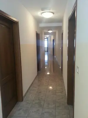 a hallway of a building with doors and a tile floor at Arkade turizem in Črniče