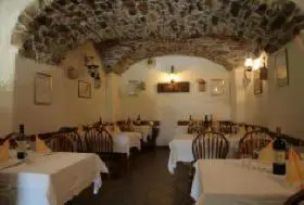 a dining room with white tables and chairs in a restaurant at Arkade turizem in Črniče