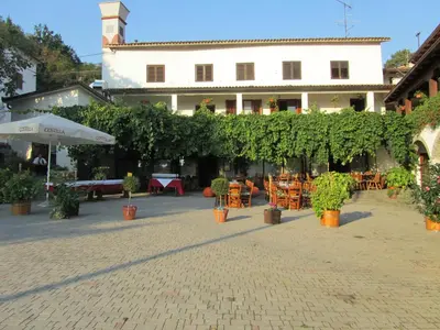 a courtyard with tables and chairs and a building at Arkade turizem in Črniče