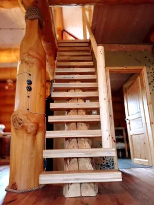 a spiral staircase in a log cabin at Brunarica Biopark -Log house Biopark in Grosuplje