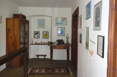 a hallway with a room with a desk and pictures on the wall at A lovely house in Vipava valley in Vipava