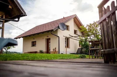 a small white house with a roof at Holiday house Aronija in Šmarje pri Jelšah