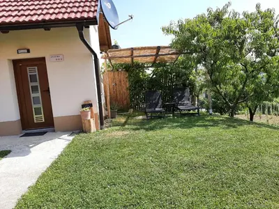 a backyard with two chairs and a pergola at Holiday house Aronija in Šmarje pri Jelšah
