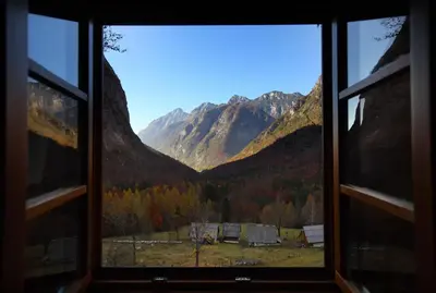 a window with a view of a mountain range at Zadnjica Holiday House in Soča