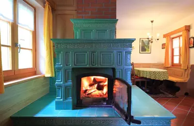 a fireplace in the middle of a room at Zadnjica Holiday House in Soča