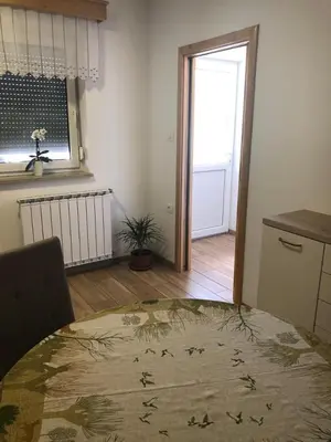 a room with a bed and a kitchen with a window at Deno in Podgrad