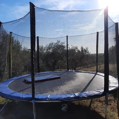 a trampoline with a net on top of it at Apartma Rok in Plavje
