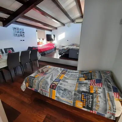 a room with a bed and a room with a bedroom at Apartma Rok in Plavje