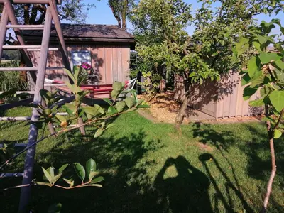 a garden with a bench and a wooden fence at Glamping with a view in Smlednik