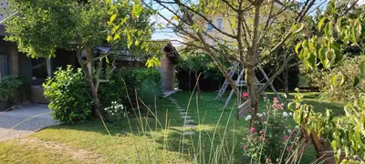 a garden with trees and flowers in a yard at Glamping with a view in Smlednik