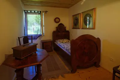 a bedroom with a bed and a table and a desk at Apartma Caprivi Zavod za razvoj turizma Kočevski rog in Kočevje