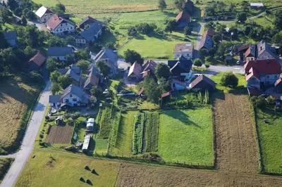 an aerial view of a village with houses and a road at Apartma Caprivi Zavod za razvoj turizma Kočevski rog in Kočevje