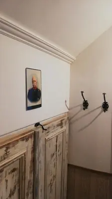 a room with a picture of a man on the wall at Apartma Caprivi Zavod za razvoj turizma Kočevski rog in Kočevje