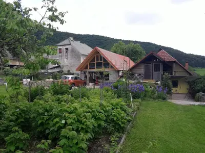 a house with a garden in the yard at Apartma Caprivi Zavod za razvoj turizma Kočevski rog in Kočevje