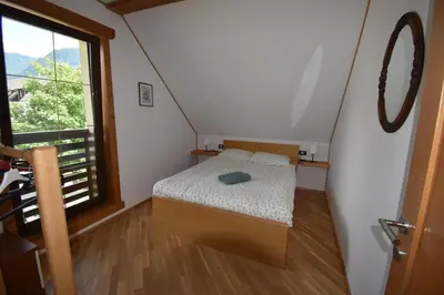 a small room with a bed and a window at Apartma Tima in Bovec