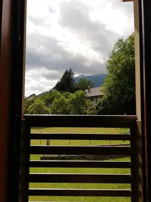 a view of a field from a window at Apartma Tima in Bovec