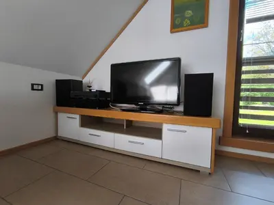 a flat screen tv sitting on top of a entertainment center at Apartma Tima in Bovec