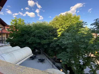 a view of a patio with chairs and trees at Apartment above Lake Bled in Bled