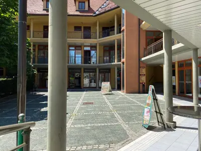 an empty parking lot in front of a building at Apartment above Lake Bled in Bled