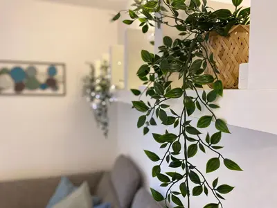 a green plant in a living room with a couch at Apartment above Lake Bled in Bled