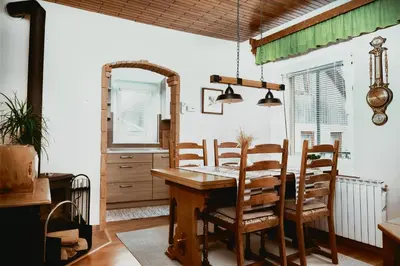 a dining room with a wooden table and chairs at Schneider Living in Bovec