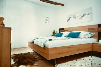 a bedroom with a bed with blue and white pillows at Schneider Living in Bovec
