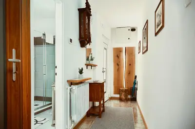 a hallway with a shower and a glass door at Schneider Living in Bovec