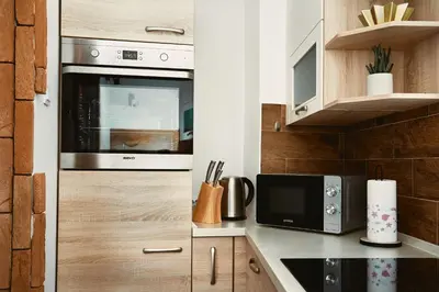 a kitchen with a stove and a microwave at Schneider Living in Bovec