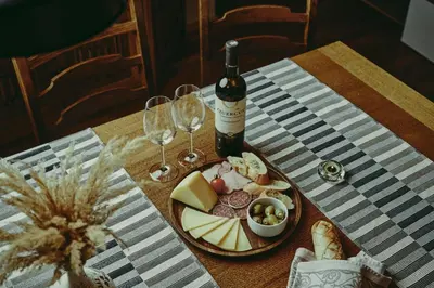 a table with a plate of food and wine glasses at Schneider Living in Bovec