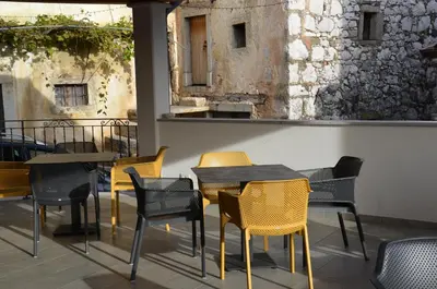 a group of tables and chairs on a patio at Apartmaji Tanto Malovše in Črniče