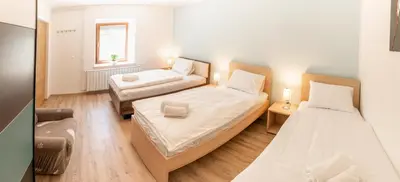a bedroom with two beds and a window at House Hiperbola & Outdoor Activities in Bovec