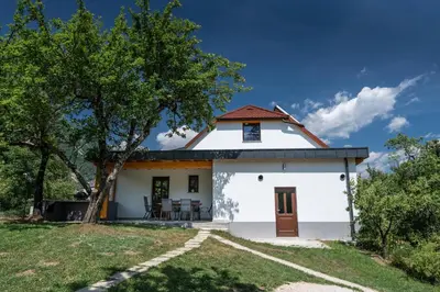 a white house with a red roof at House Hiperbola & Outdoor Activities in Bovec