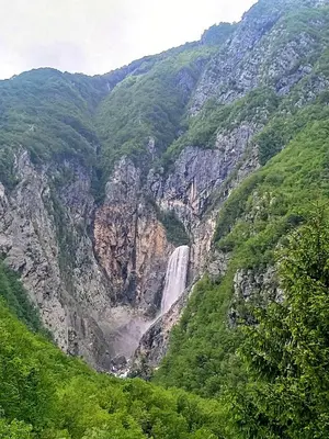 a waterfall on the side of a mountain at Pri Zajcu in Bovec