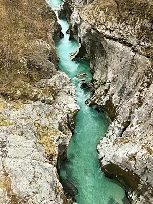a river in a rocky canyon with green water at Pri Zajcu in Bovec