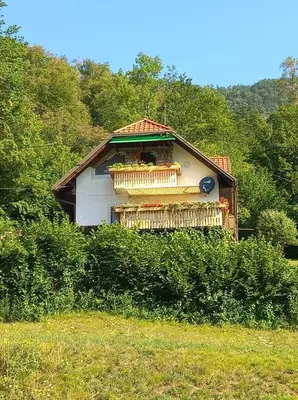 a small house with a balcony in a field at APARTMENT WITH A VIEW in Bohinjska Bistrica