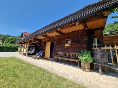 a wooden house with a bench in front of it at Počitniška hišica Žagar in Podčetrtek