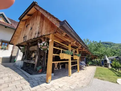 a large wooden building with a roof at Počitniška hišica Žagar in Podčetrtek