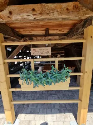 a wooden table with some plants in it at Počitniška hišica Žagar in Podčetrtek